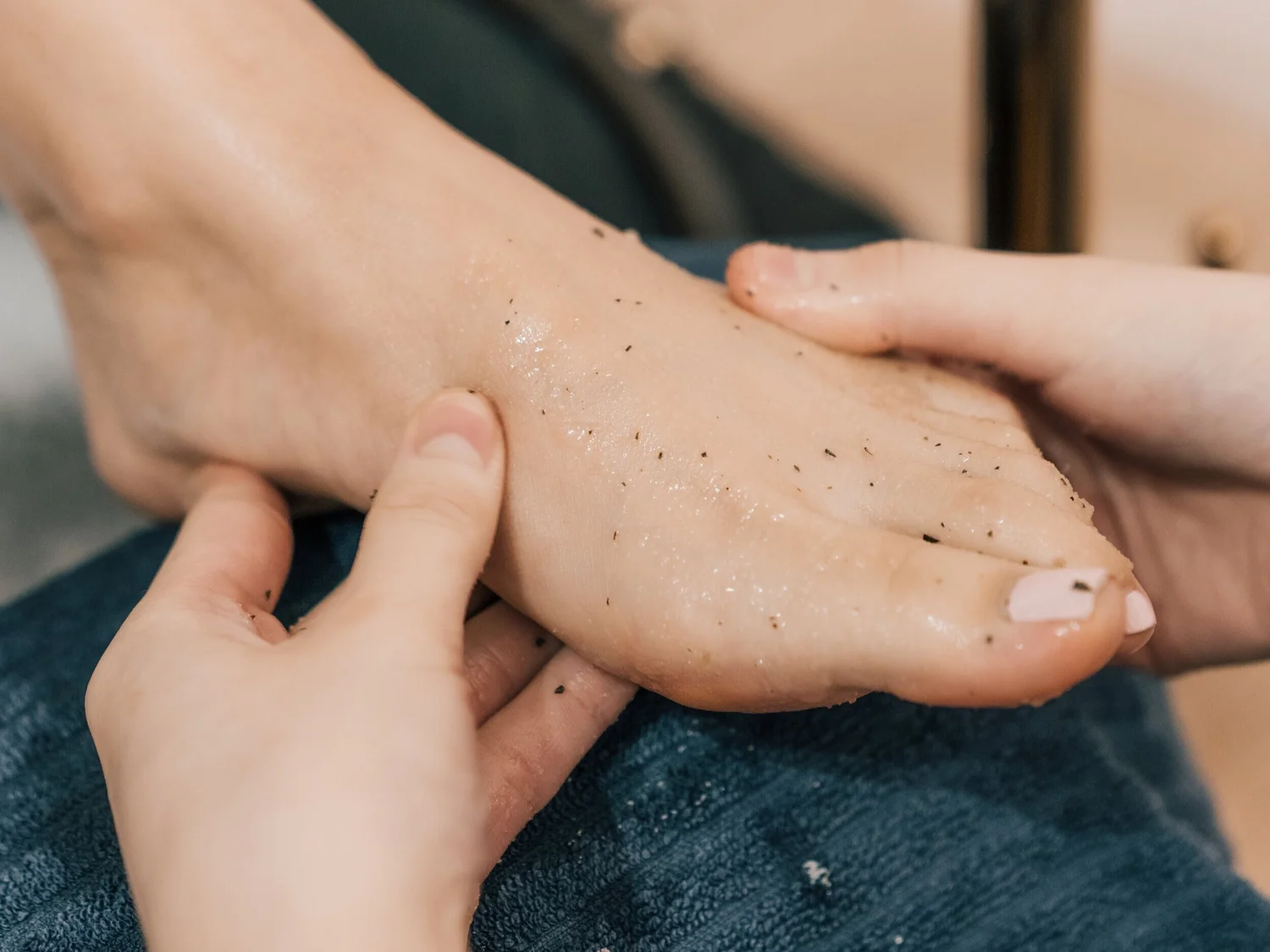 Foot exfoliation during a pedicure at Liveo Beauty